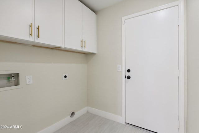 laundry area featuring washer hookup, hookup for an electric dryer, light hardwood / wood-style floors, and cabinets