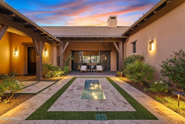 patio terrace at dusk with an outdoor living space