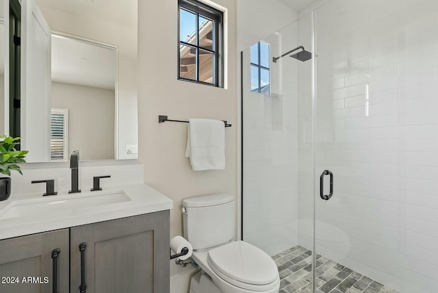 bathroom featuring vanity, toilet, and walk in shower