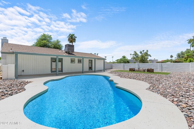 view of pool with central AC and a patio