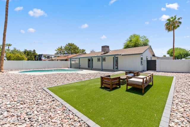 back of house featuring a fenced in pool and a patio