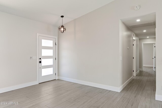 unfurnished living room featuring a tile fireplace, vaulted ceiling, light hardwood / wood-style floors, and ceiling fan