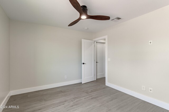 unfurnished bedroom with ceiling fan, a closet, and light hardwood / wood-style floors