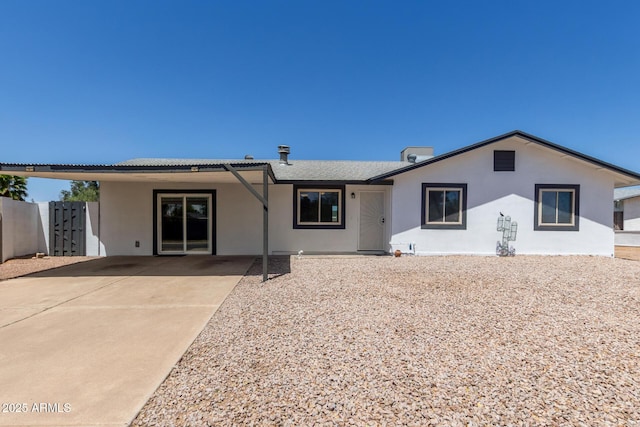 view of front of house featuring a patio, fence, and stucco siding