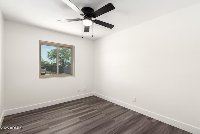 unfurnished room with dark wood-style flooring, baseboards, and a ceiling fan