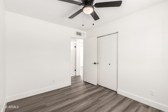 unfurnished bedroom featuring visible vents, baseboards, and wood finished floors