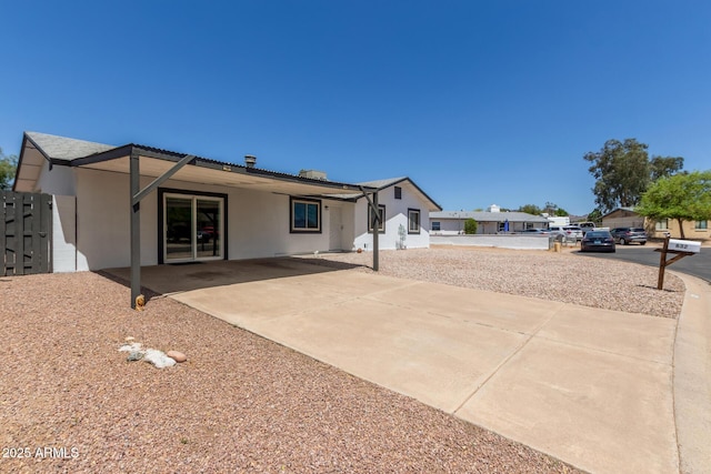 back of property with stucco siding and a patio area