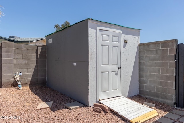 view of shed featuring fence