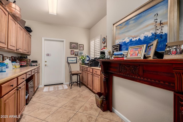 3166 N 158th Ave, Goodyear, AZ 85395 - kitchen with light tile patterned floors, light countertops, and a desk