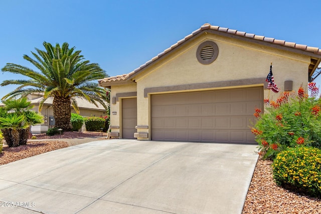 3166 N 158th Ave, Goodyear, AZ 85395 - mediterranean / spanish-style home featuring stucco siding, an attached garage, a tile roof, and concrete driveway