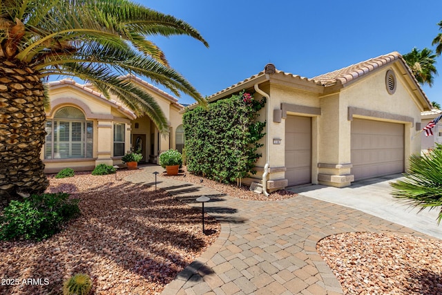 3166 N 158th Ave, Goodyear, AZ 85395 - mediterranean / spanish-style home with a garage, concrete driveway, stucco siding, and a tiled roof