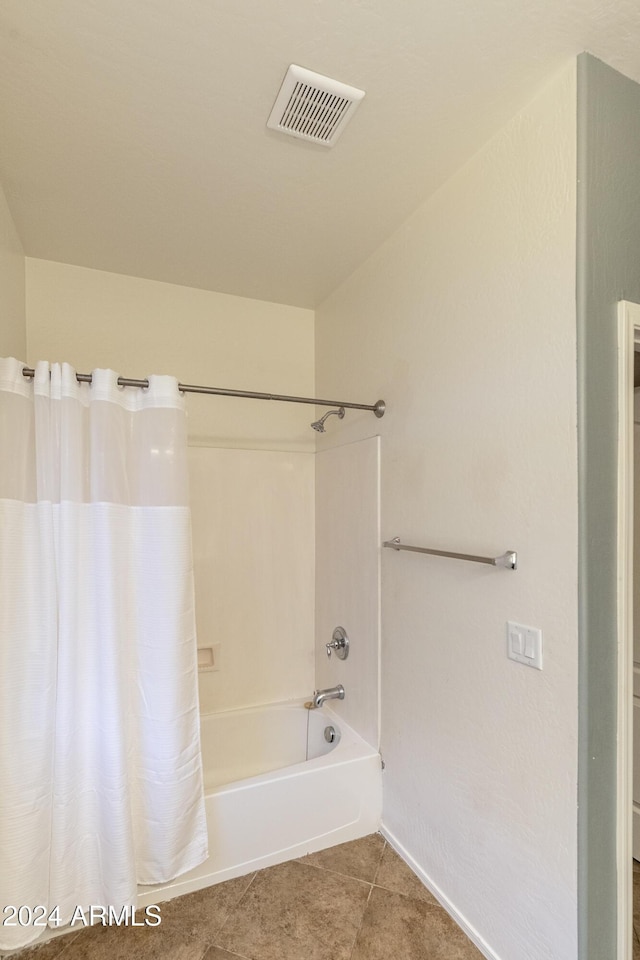 bathroom with shower / bath combination with curtain and tile patterned floors