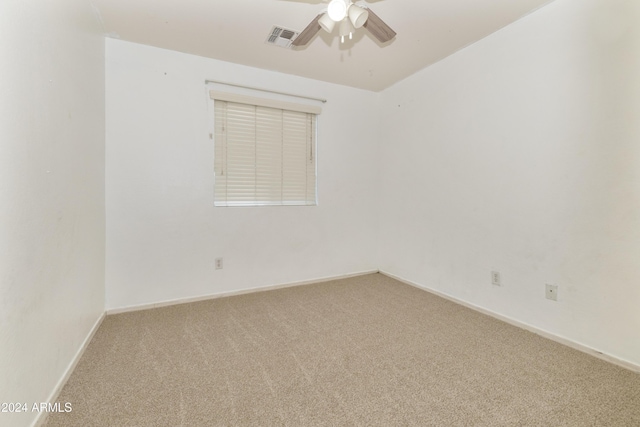 carpeted empty room featuring ceiling fan