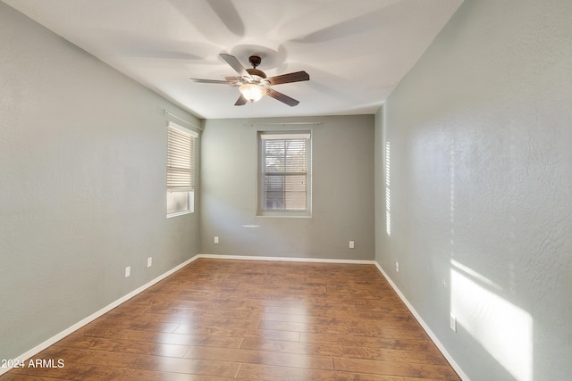 empty room featuring ceiling fan and dark wood-type flooring