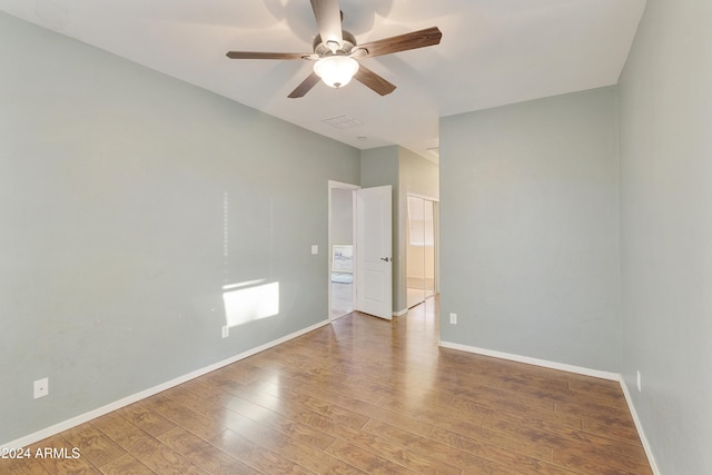 unfurnished room with hardwood / wood-style flooring and ceiling fan