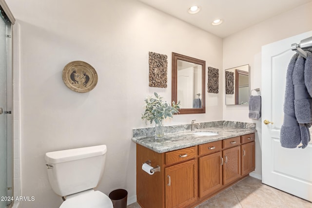 bathroom with tile patterned flooring, vanity, and toilet