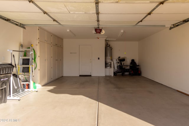 garage with gas water heater and a garage door opener