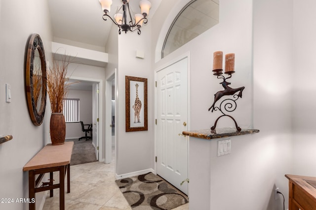 tiled entryway with an inviting chandelier