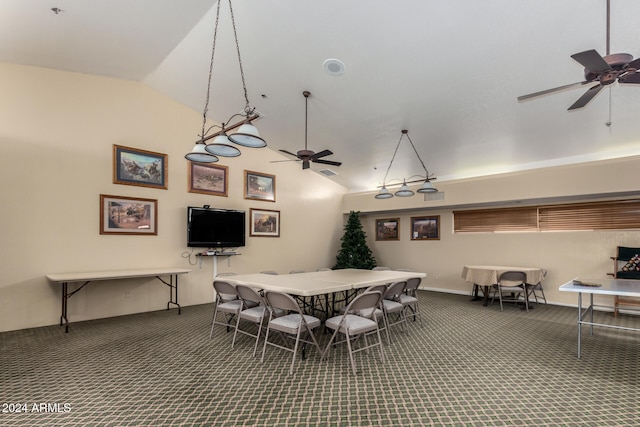 carpeted dining space featuring ceiling fan and lofted ceiling