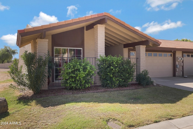 view of front of home with a garage and a front yard