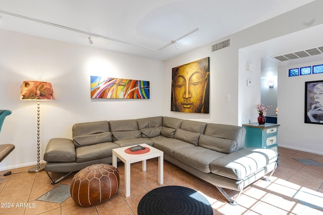 tiled living room featuring rail lighting