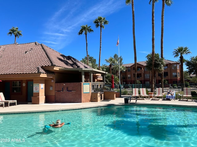 view of swimming pool with a patio area