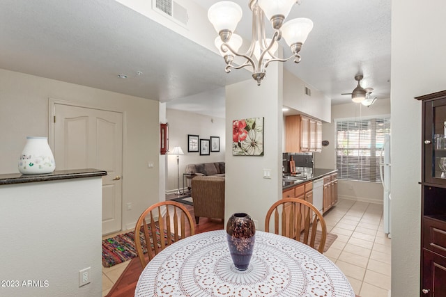 dining area with light tile flooring and ceiling fan with notable chandelier