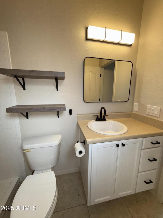 bathroom with toilet, tile patterned flooring, and vanity