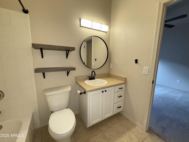 bathroom featuring  shower combination, vanity, toilet, and tile patterned floors