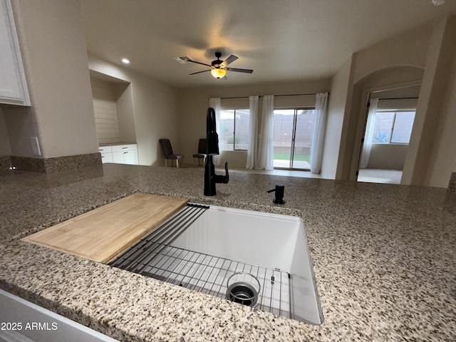 kitchen featuring a sink, a ceiling fan, visible vents, and a wealth of natural light