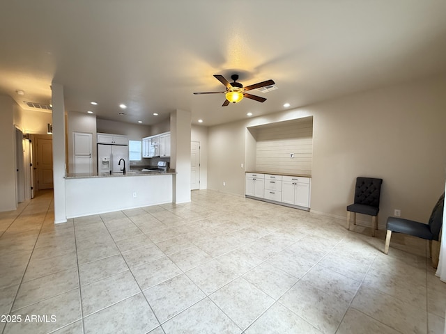 unfurnished living room with recessed lighting, ceiling fan, baseboards, and light tile patterned floors