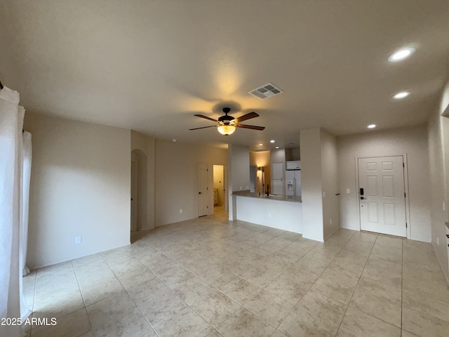 unfurnished living room featuring ceiling fan, visible vents, arched walkways, and recessed lighting