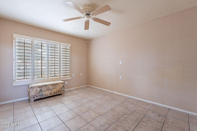 unfurnished room with ceiling fan and light tile patterned floors