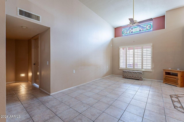 interior space featuring ceiling fan and a towering ceiling