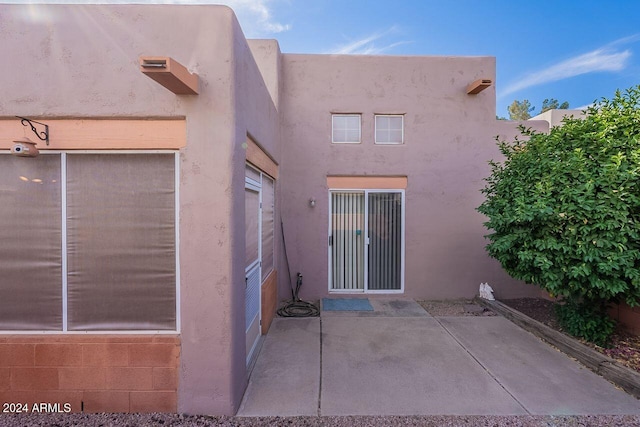 back of property with a patio