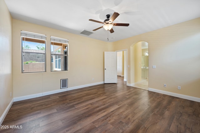 21017 W Edith Way, Buckeye, AZ 85396 - unfurnished bedroom with arched walkways, dark wood-style floors, and ensuite bathroom