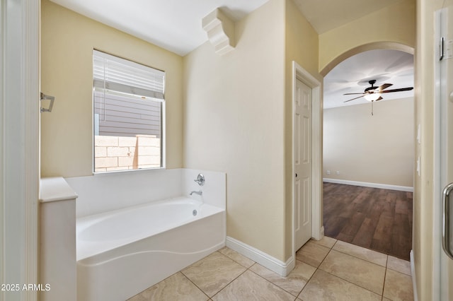 21017 W Edith Way, Buckeye, AZ 85396 - full bathroom with a garden tub, a ceiling fan, and tile patterned flooring