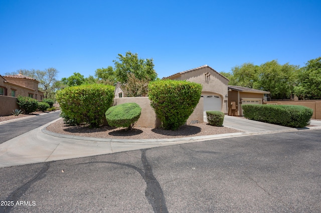 21017 W Edith Way, Buckeye, AZ 85396 - view of front of house with an attached garage, stucco siding, and driveway