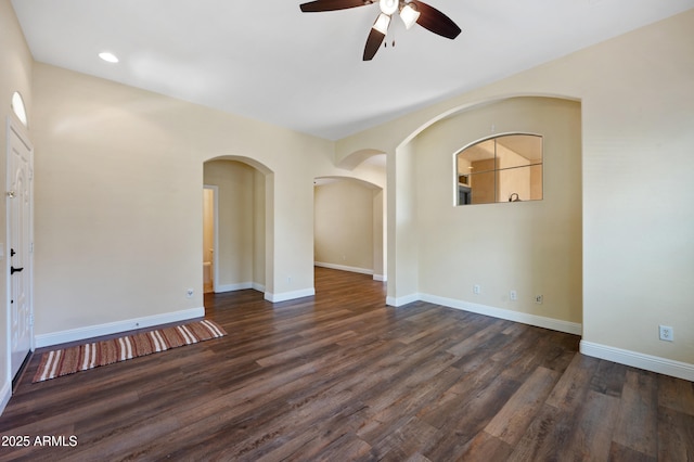 21017 W Edith Way, Buckeye, AZ 85396 - empty room featuring ceiling fan, dark wood finished floors, and arched walkways