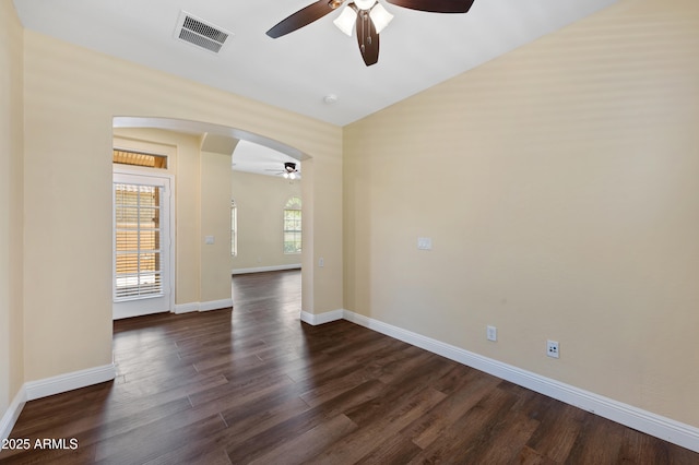 21017 W Edith Way, Buckeye, AZ 85396 - unfurnished room featuring a ceiling fan, arched walkways, and dark wood-type flooring