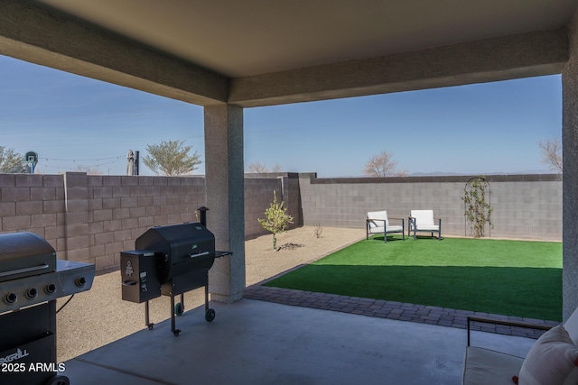 view of patio / terrace with grilling area and a fenced backyard