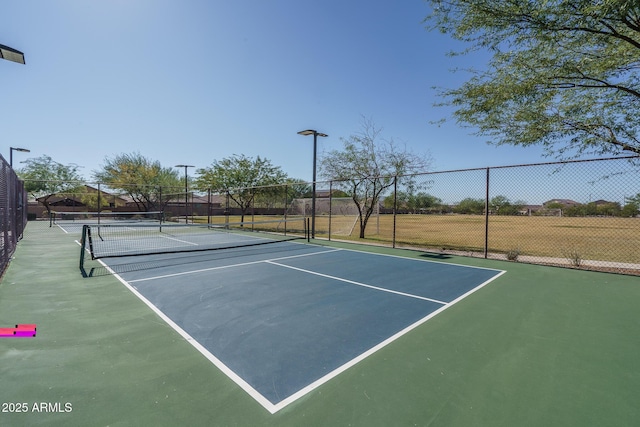 view of sport court with fence