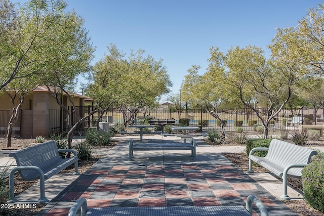 view of property's community featuring fence and a patio