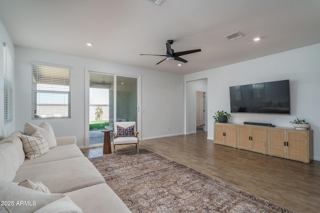 living room with wood finished floors, visible vents, and recessed lighting