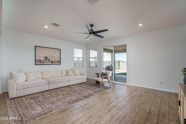 living room featuring recessed lighting, visible vents, a ceiling fan, wood finished floors, and baseboards