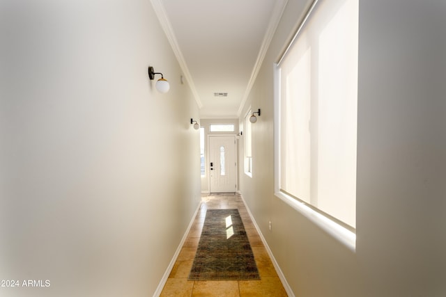 hallway featuring plenty of natural light and crown molding