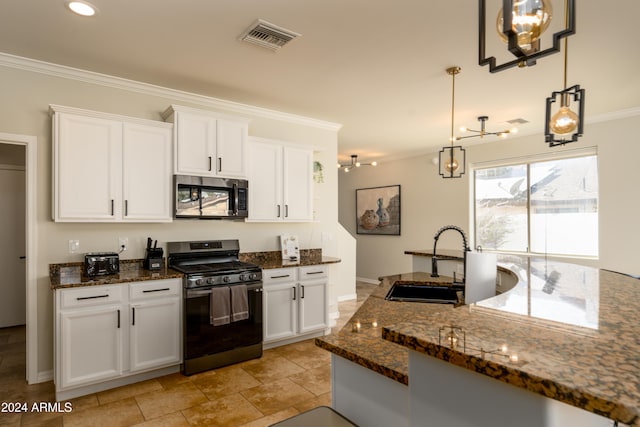 kitchen featuring white cabinetry, sink, appliances with stainless steel finishes, dark stone countertops, and decorative light fixtures