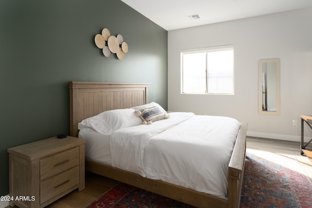 bedroom with wood-type flooring