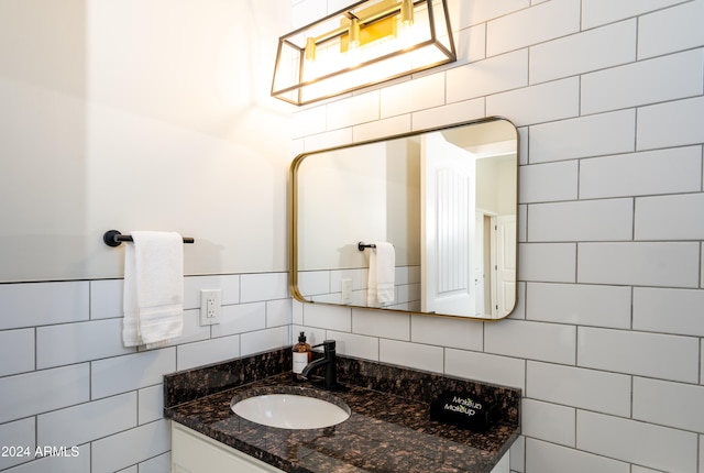 bathroom with vanity, tile walls, and tasteful backsplash