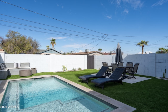 view of swimming pool with a lawn and a patio area